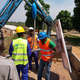 Solar technicians with Aptech Africa raise one of sixty-two solar streetlights they installed in Paoua, Central African Republic.